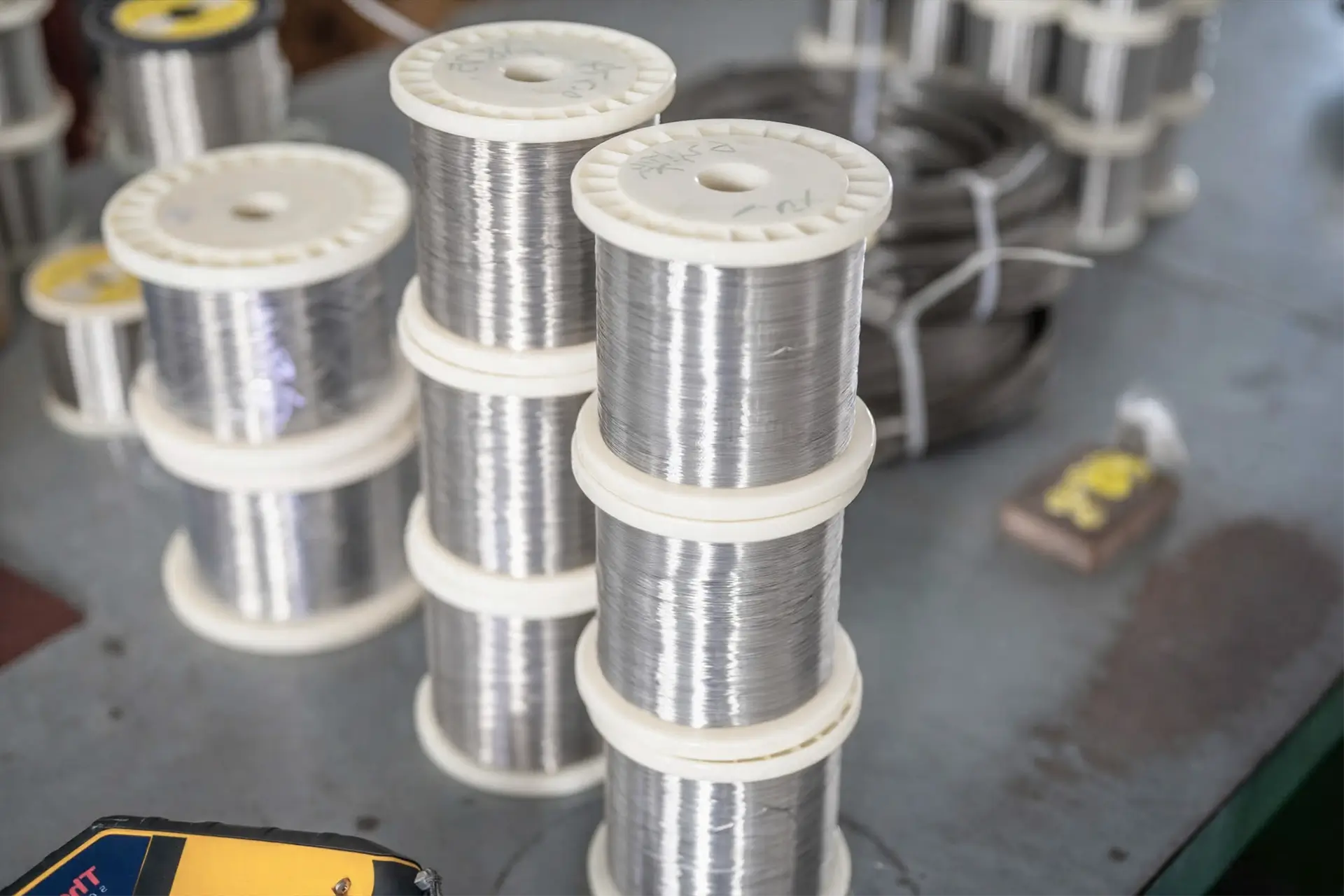 Arialloy manufactured nickel alloy fine wire wire spool stack close up